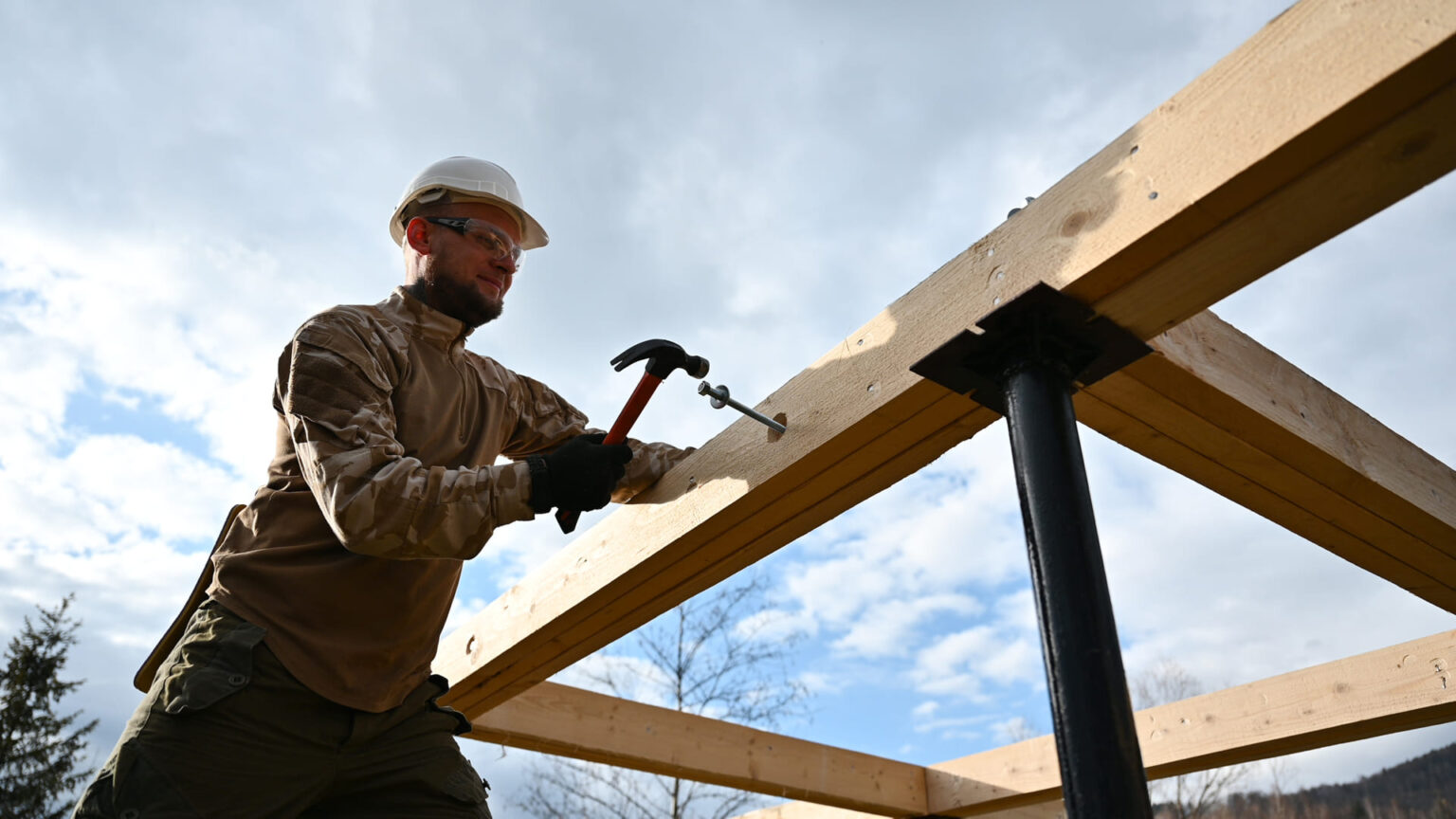 man-worker-hammering-while-building-wooden-frame-h-2025-01-16-23-03-20-utc