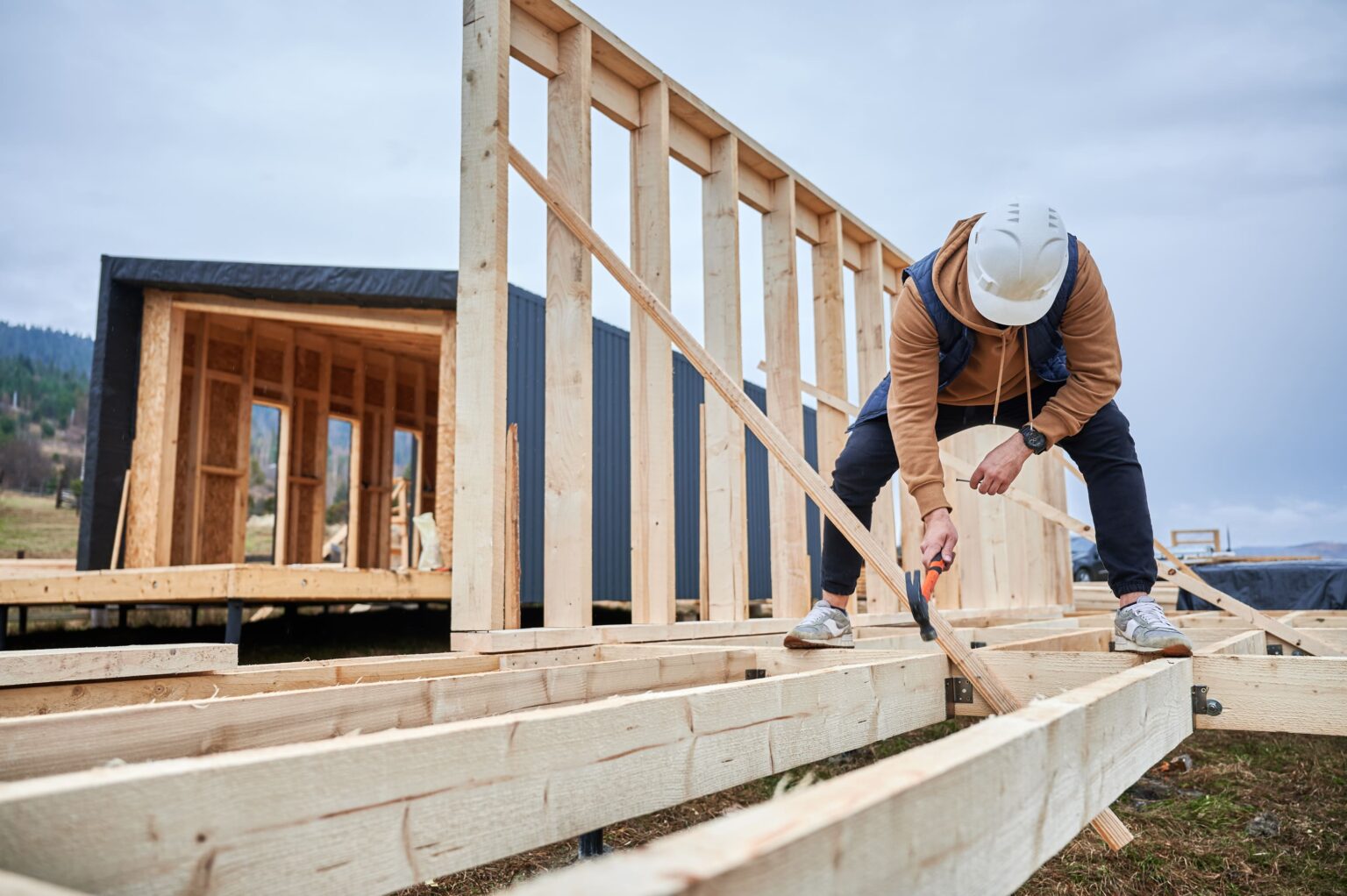 man-worker-hammering-while-building-wooden-frame-h-2025-01-16-23-38-18-utc